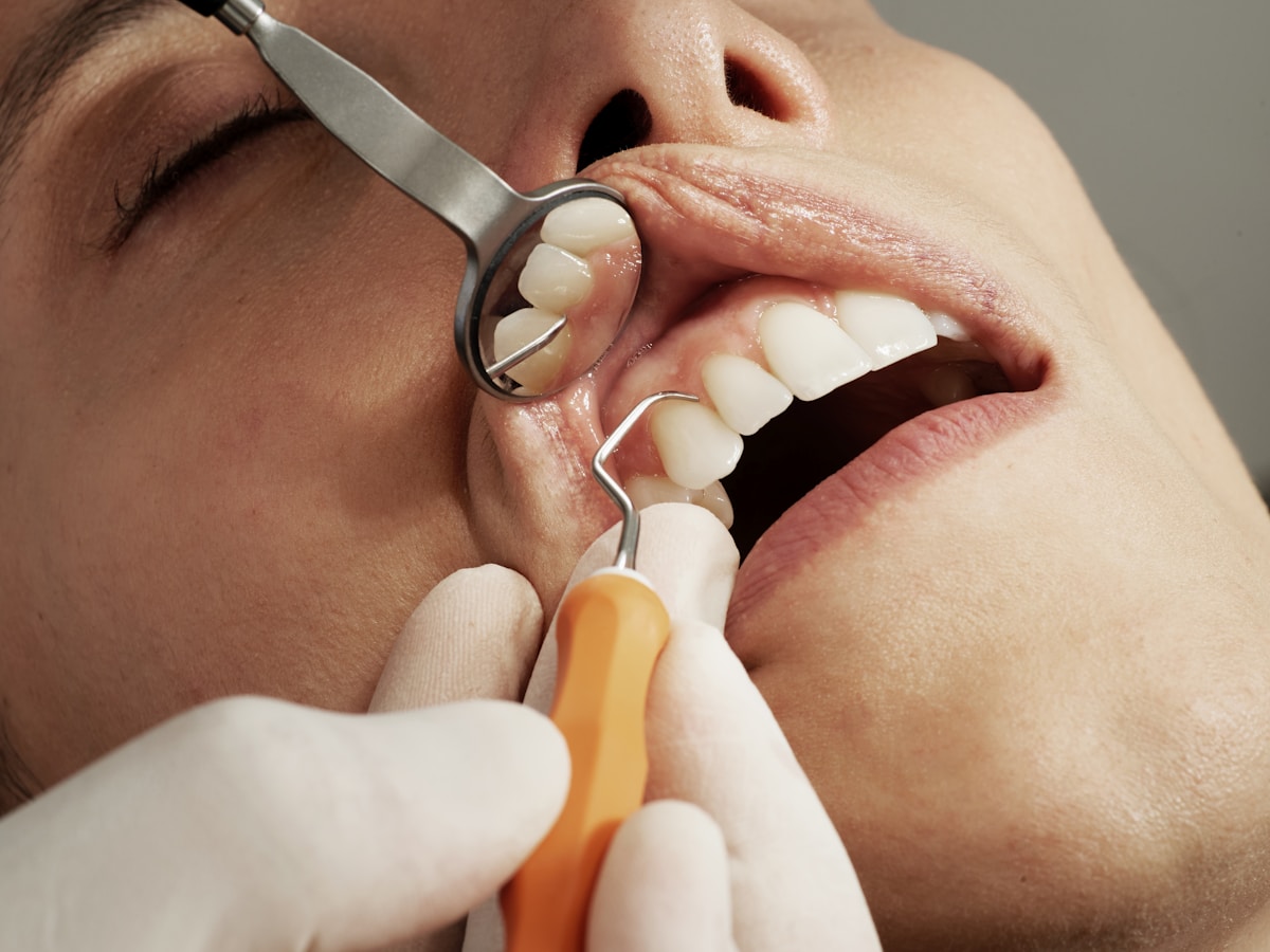 A dentist preparing treatment in a bright modern care room